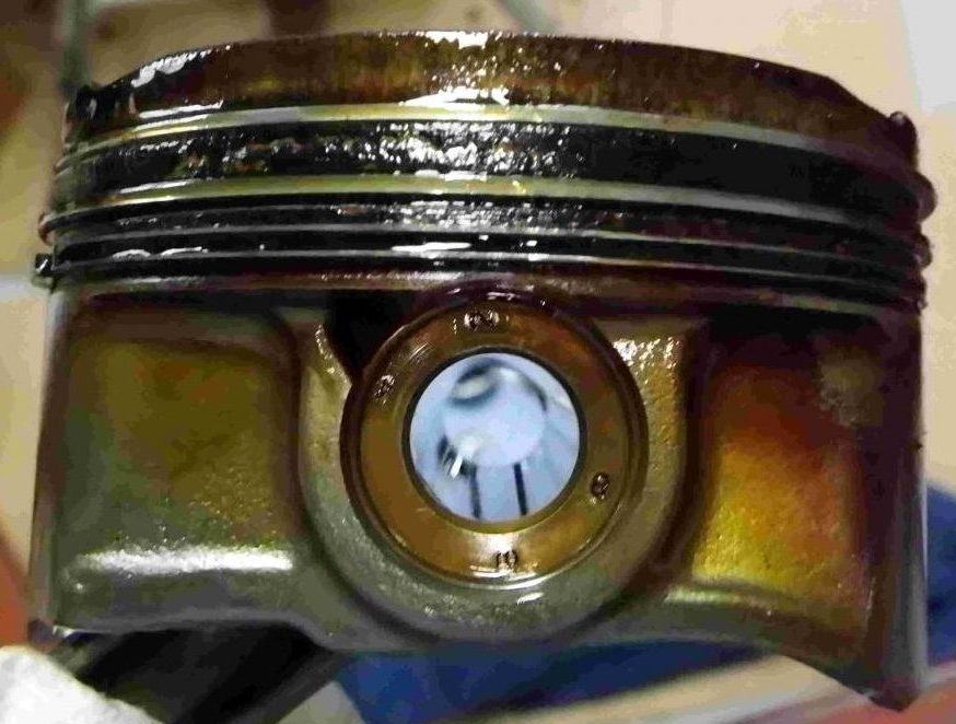 piston with sludge and hard carbon causing engine blow-by